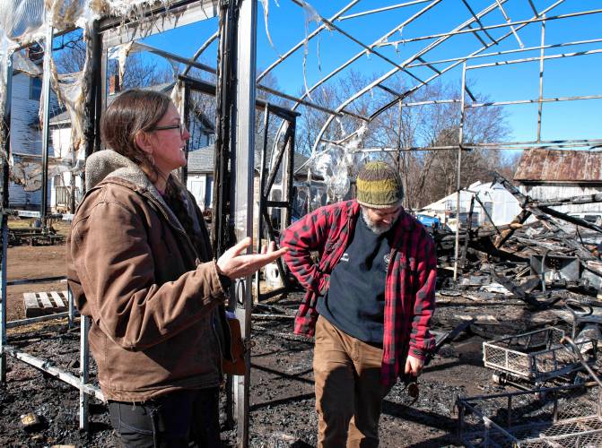 Sarah and Ryan Voiland, owners of Red Fire Farm in Granby, talk on Tuesday about the damage from the fire Saturday afternoon and what it will take to rebuild.