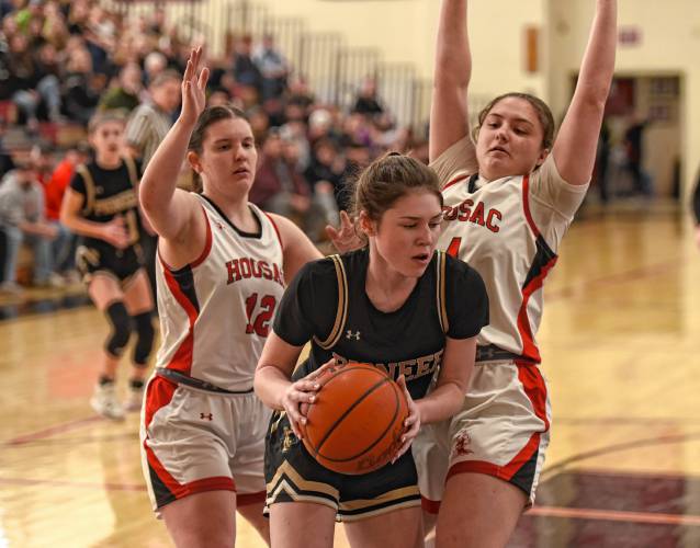 Pioneer’s Addie Harrington holds possession down low while defended by Hoosac Valley’s Emma Meczywor (12), left, and Hoosac’s Maryn Cappiello (4) during the Panthers’ 57-35 loss in the Western Mass. Class D championship game on Saturday at Westfield High School.