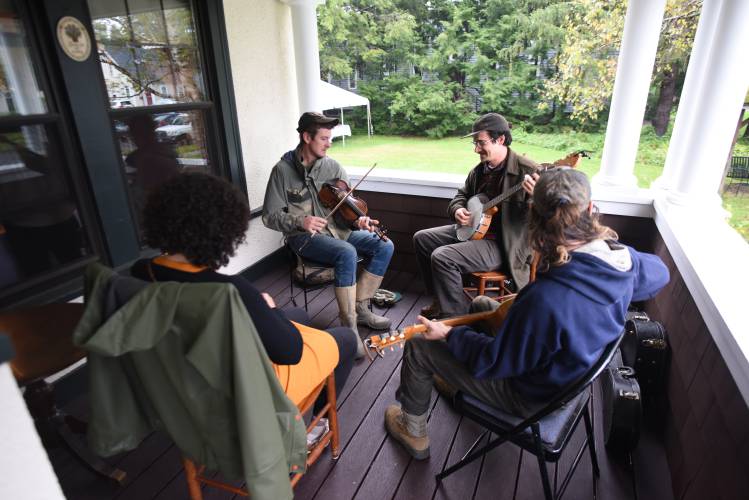 Musicians jam on the front porch at the New England Learning Center for Women in Transition (NELCWIT) on Long Avenue in Greenfield.