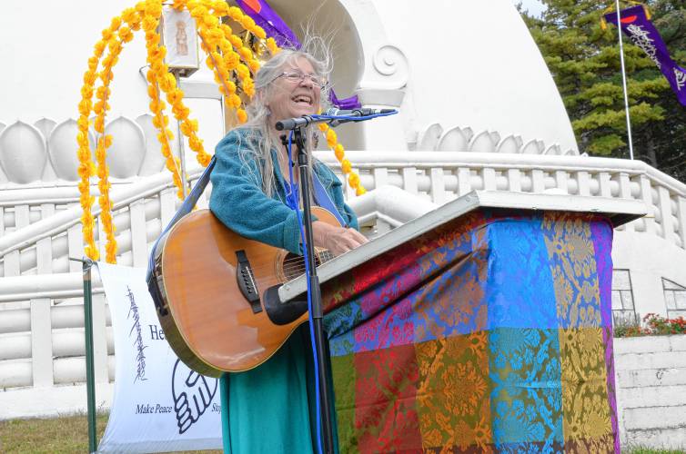 Shelburne Falls musician Sarah Pirtle performs songs of peace during the 38th anniversary celebration for the New England Peace Pagoda in Leverett on Sunday.