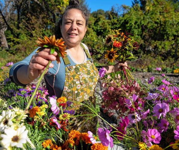 Suna Turgay, a co-owner of Flowerwork Farm, makes bouquets after harvesting the flowers in fields in Florence on Oct. 13.