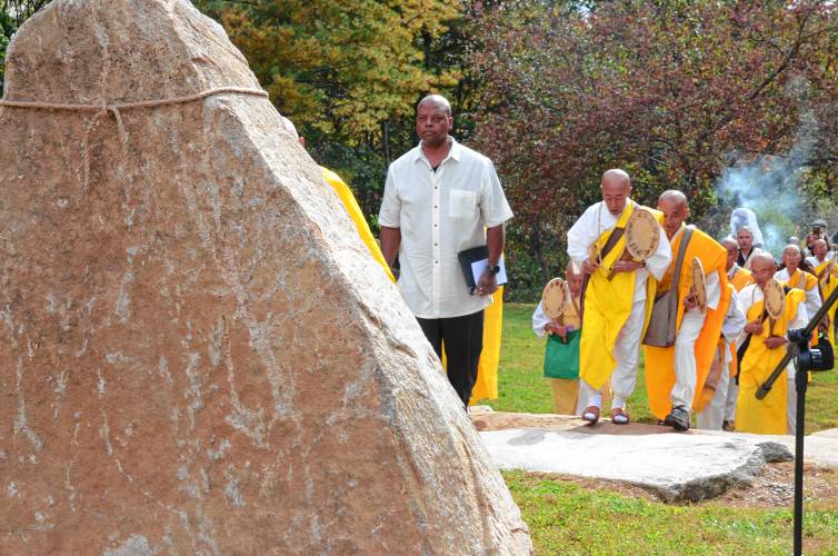 Monks march toward the monument dedicated to late Wampanoag medicine man Slow Turtle during the 38th anniversary celebration for the New England Peace Pagoda in Leverett on Sunday.