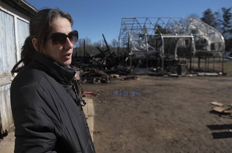 Stephanie Kennedy, the farm manager at Red Fire Farm in Granby, talks Monday morning about the fire  that burnt a barn and green house Saturday afternoon.