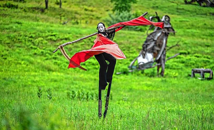 Double Edge Theatre ensemble actor Hannah Jarrell dances with a scythe during a rehearsal on Friday, July 10, 2020, for the Ashfield troupe’s Summer Spectacle, “6 Feet Apart, All Together.”