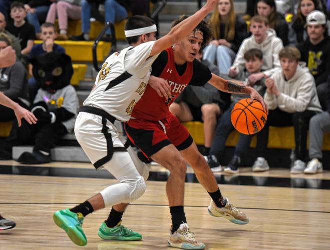 Athol’s Angel Castillo drives against Pioneer’s Alex McClelland during the host Panthers’ 42-32 victory in the MIAA Division 5 Round of 16 on Tuesday night at Messer Gymnasium in Northfield.