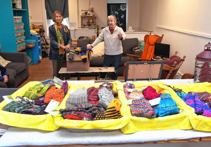 Lina Bernstein, left, is assisting her sister-in-law Katherine Erwin, of Orange, to deliver socks to Ukrainian soldiers through RememberUs.org. Erwin and other knitters of the Dragonfly Sock Knitters crafted the socks in their Orange storefront studio.