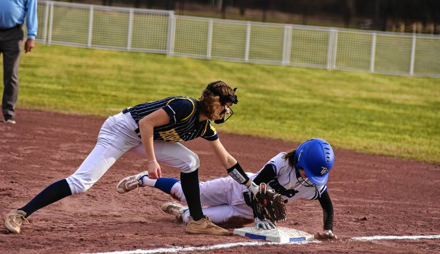 Hopkins Academy first baseman Alayna Bailey, left, puts a tag down on Turners Falls baserunner Addison Talbot (10) during the host Thunder’s season-opening victory on Monday at Gary  Mullins Field in Turners Falls.