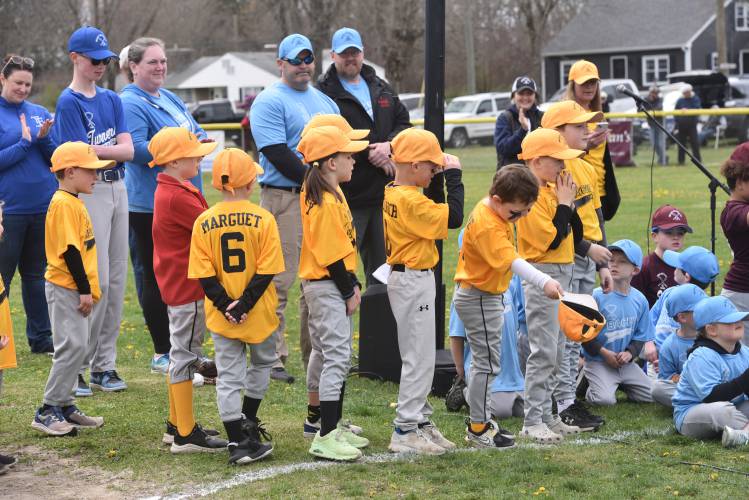 A Travel Kuz player tips his cap after his  name was announced during the Opening Day ceremony at the Newt Guilbault Fields Sunday. 