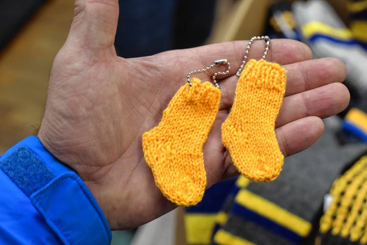 Small sock key chains are being sold to raise money to send socks, made by the Dragonfly Sock Knitters in Orange, to soldiers in Ukraine.