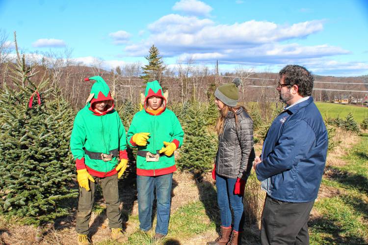 Brothers and the fifth-generation of Cranston’s Tree Farm farmers Oliver and Cyrus Cranston speak to Massachusetts Department of Agricultural Resources Commissioner Ashley Randle and state Sen. Paul Mark while leading a tour of the Ashfield farm on Friday.
