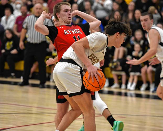 Athol’s Colby Goodwin (11) defends Pioneer’s Kurt Redeker during the host Panthers’ 42-32 victory in the MIAA Division 5 Round of 16 on Tuesday night at Messer Gymnasium in Northfield.