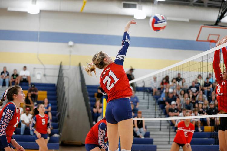 Frontier’s Olivia Machon (21) hits against Baystate Academy in the fourth set of the Western Mass. Class B girls volleyball final Saturday at Chicopee Comp.