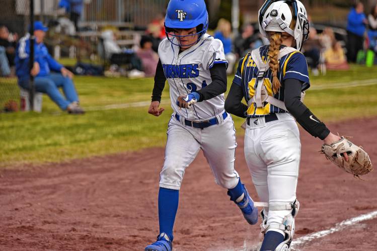 Turners Falls’ Ivy Lopez (24) touches home plate for a run against Hopkins Aadduring the host Thunder’s season-opening victory on Monday at Gary  Mullins Field in Turners Falls.