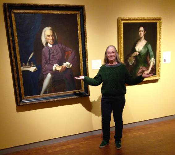 Sara Campbell stands in front of paintings of John and Abigail Erving that are housed at the Smith College Museum of Art.