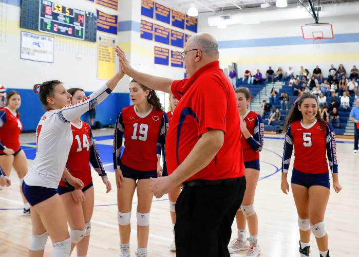 Frontier head coach Sean MacDonald high fives Ariana Miller during a timeout against Baystate Academy in the fourth set of the Western Mass. Class B girls volleyball final Saturday at Chicopee Comp.