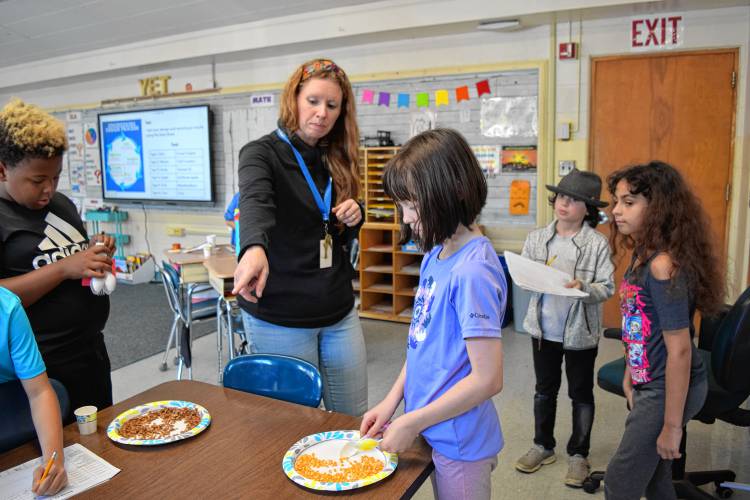 Buckland-Shelburne Elementary School teacher Jackie Fuller explores different “beak” designs with her fourth grade class, symbolizing different types of birds. They put their beaks to the test by trying to pick up different foods, learning about the advantages of the different designs.