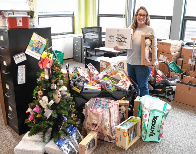 Meg Tudryn, public heatlh nurse for the city of Greenfield, with toys collected for local families.