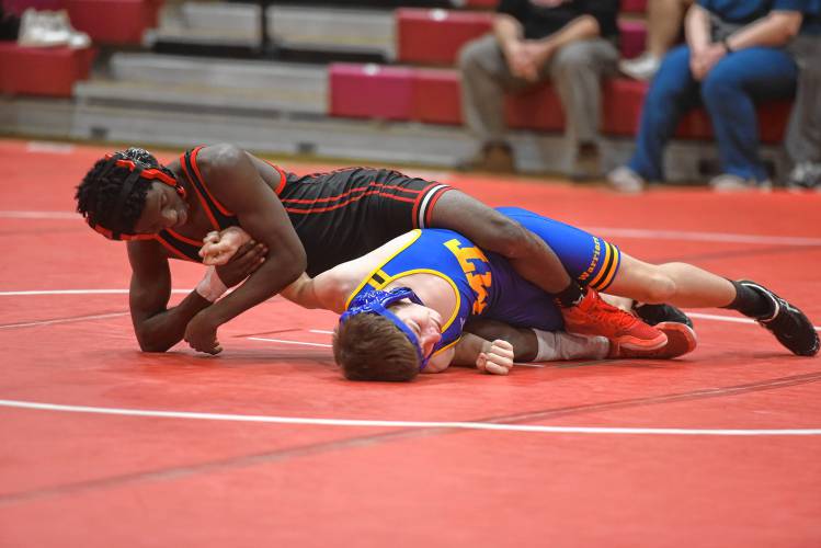 Athol’s Abduli Gilmore attemps to secure a pin on Mohawk Trail’s Danny Gougeon on Tuesday at Mallet Gymnasium.