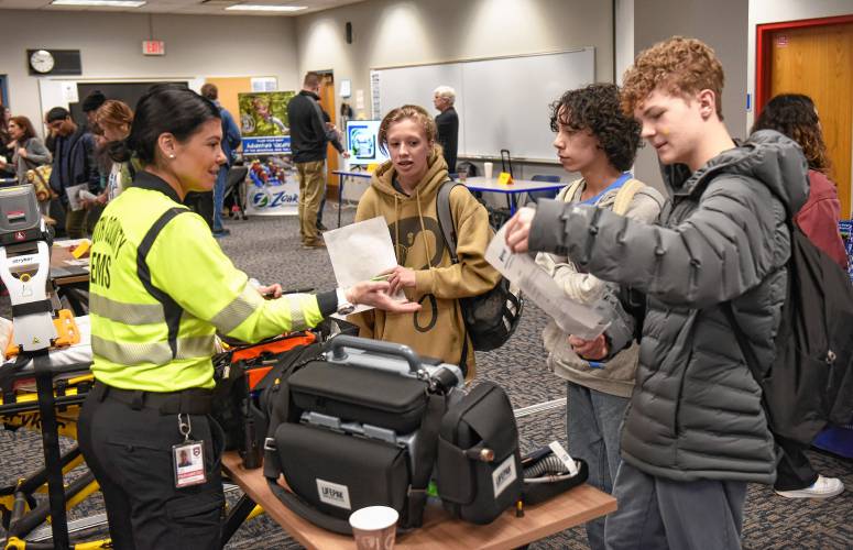 Paramedic Alicia Toia of South County EMS talks with Frontier Regional School students Kali Beam, Noah Smith and Gus Musante at a career fair at the school on Wednesday.