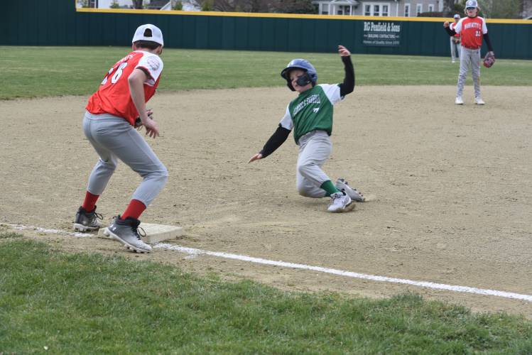 Gilmore and Farrell’s Paul Budrawich slides into third during a GMLB game against Maniatty’s on Sunday at Lunt Field. 