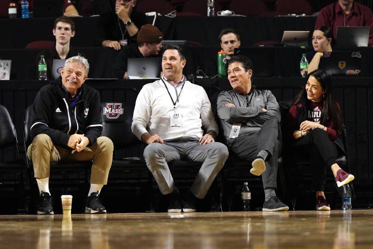 UMass Director of Athletics Ryan Bamford, center, sits beside football coach Don Brown, left, Chancellor Javier Reyes, right, and his wife, Maritza Reyes, during a men’s basketball game against Albany last month at the Mullins Center in Amherst.