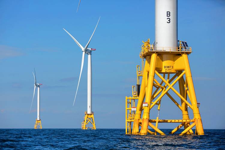 In this Aug. 15, 2016 file photo, three of Deepwater Wind’s five turbines stand in the water off Block Island, Rhode Island, the nation’s first offshore wind farm.