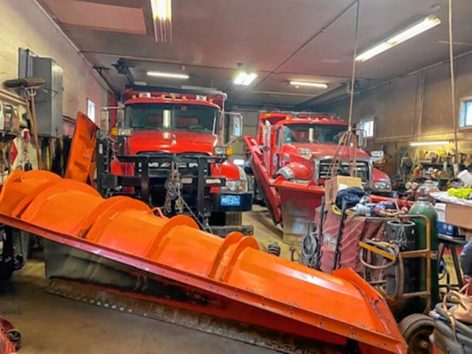 Two of the Goshen Highway Department’s smaller trucks fill the bays in the garage.