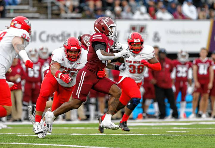 Umass running back Kay'Ron Lynch-Adams (15) rushes against New Mexico in the second quarter Saturday at McGuirk Alumni Stadium in Amherst.