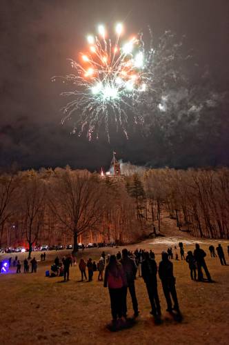 People enjoy the fireworks at Beacon Field Friday night during the 102nd annual Winter Carnival in Greenfield.
