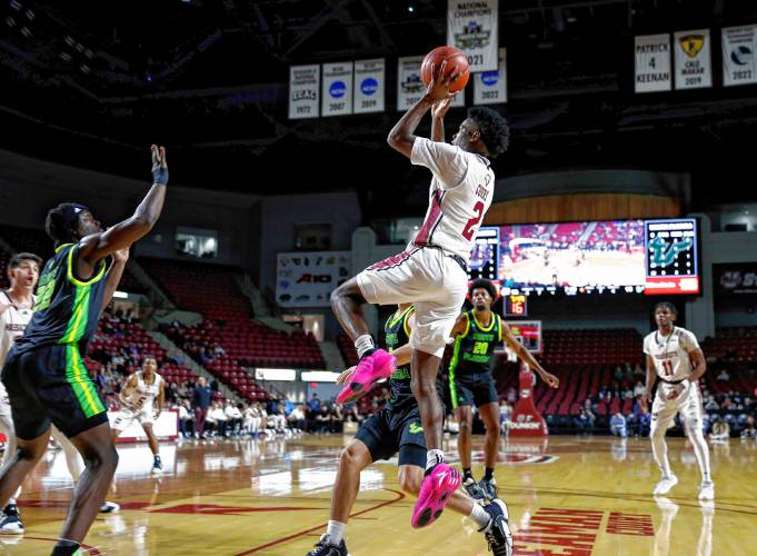UMass guard Jaylen Curry (2) takes a shot against South Florida earlier this season at the Mullins Center in Amherst.