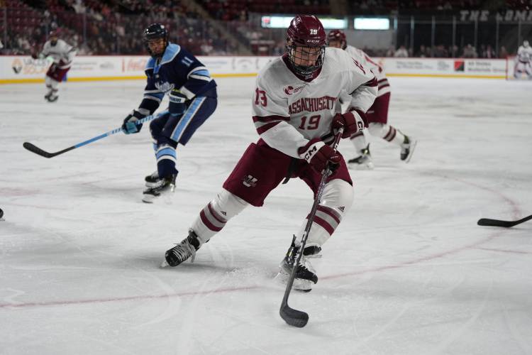 UMass’ Cole O’Hara retrieves the puck against Maine earlier this season at the Mullins Center. 