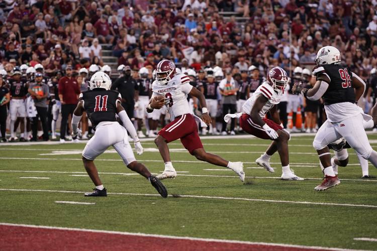 UMass quarterback Taisun Phommachanh runs in for a score against New Mexico State on Saturday in Las Cruces, N.M.