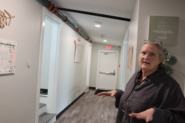 Liz Beach, program director at Sunrise Ridge in Athol, walks through the facility, which has space for 32 patients. Sunrise Ridge works with women with substance abuse and mental health disorders.