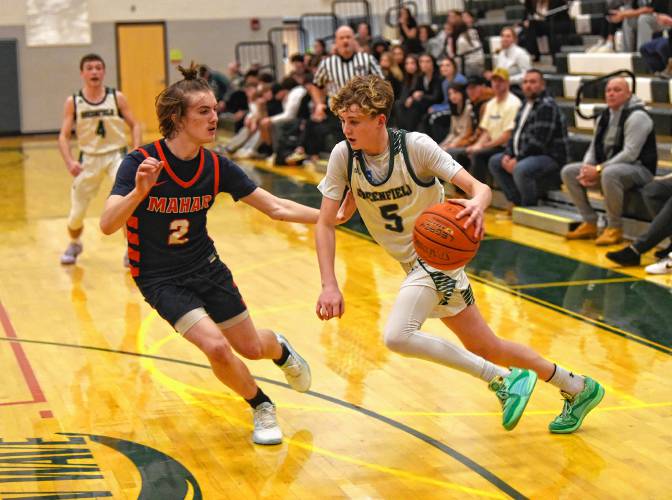 Greenfield’s Grayson Thomas (5) dribbles while defended by Mahar’s Morgan Softic (2) during Hampshire League South action at Nichols Gymnasium in Greenfield on Tuesday night.