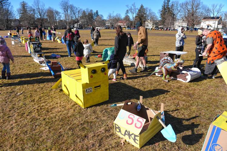 People check out and vote for their favorite creation at the cardboard sled competition on Sunday during the 102nd annual Winter Carnival in Greenfield.