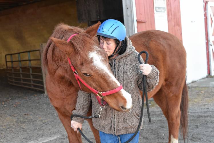 Greenfield resident Patti Rackham spends time with Logan at the Courageous Strides Therapeutic Riding Program at Stoney B Acres in Bernardston.