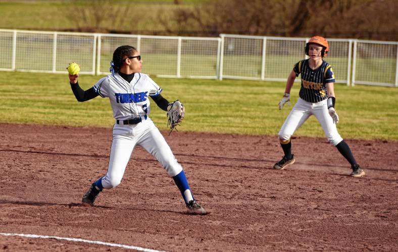 Turners Falls third baseman Marilyn Abarua (7) looks back Hopkins Academy baserunner Maggie Potter (3) during the host Thunder’s season-opening victory on Monday at Gary  Mullins Field in Turners Falls.