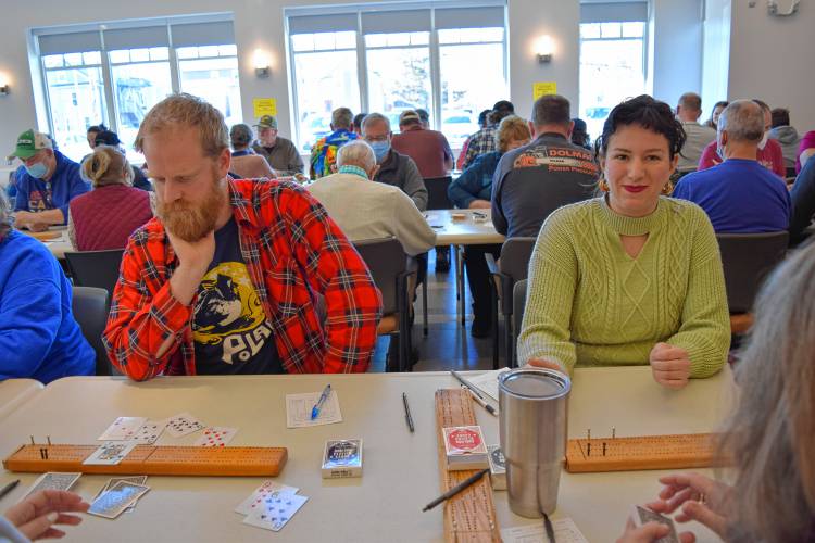 Dan Littlefield and Ruby Henry play cribbage at Saturday’s tournament as part of the 102nd annual Winter Carnival.