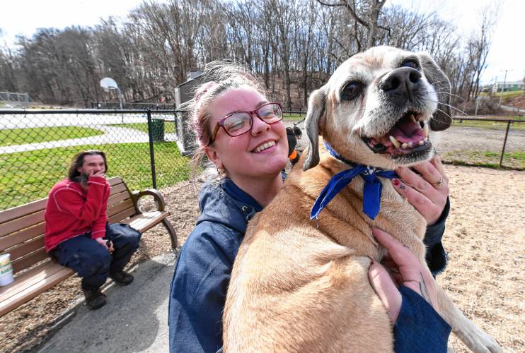 Greenfield resident Ana Montague holds her dog Huckle Badger at Paws Park at Green River Park in Greenfield on Friday.