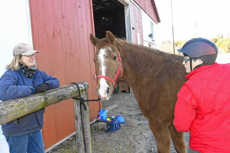 Deb Gordon, president and instructor at the Courageous Strides Therapeutic Riding Program at Stoney B Acres in Bernardston, is pictured with Logan and veteran Lori-Lee Adams.