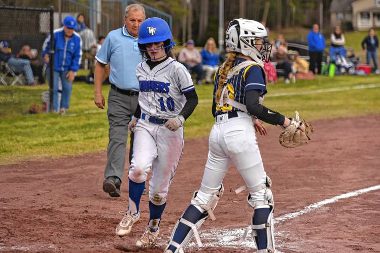 Turners Falls’ Addison Talbot (10) touches home plate for a run against Hopkins Academy during the host Thunder’s season-opening victory on Monday at Gary  Mullins Field in Turners Falls.