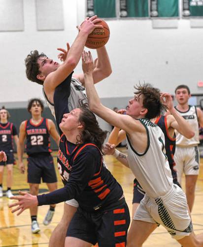Greenfield’s Jonathan Breor pulls down a rebound in traffic during Hampshire League South action at Nichols Gymnasium in Greenfield on Tuesday night.