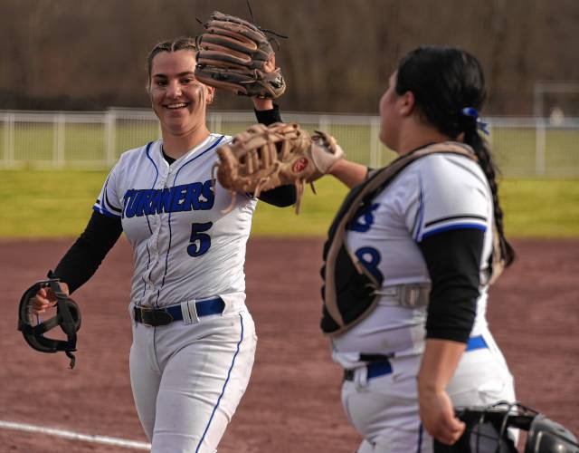 Turners Falls’ Madison Liimatainen (5) high-fives catcher Holly Myers after striking out a Hopking Academy batter to end an inning during the host Thunder’s season-opening victory on Monday at Gary  Mullins Field in Turners Falls.