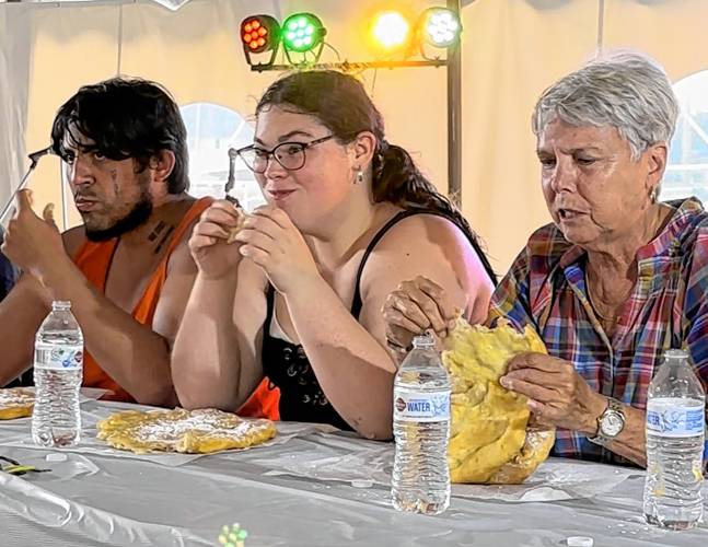 Competitive eaters chow down during the 2023 Franklin County Fair’s annual fried dough eating contest.