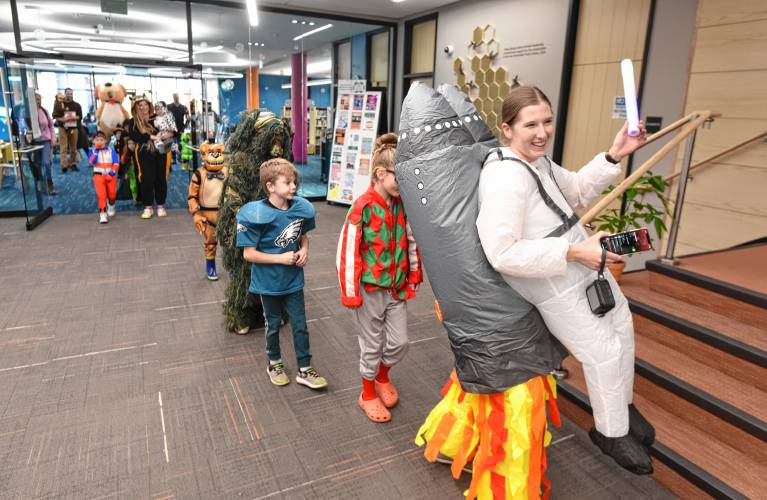 Greenfield Public Library Children’s Librarian Ellen Lavoie leads a costume parade on Tuesday followed by snacks and crafts.