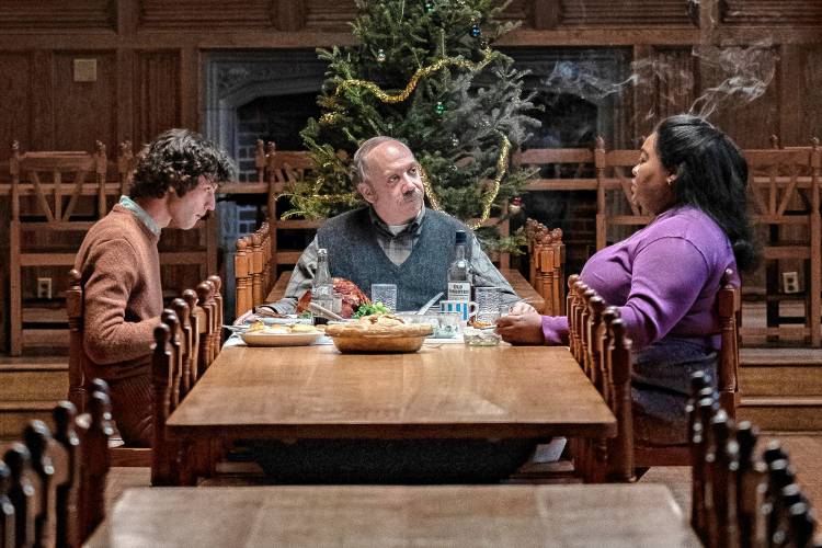 Dominic Sessa, Paul Giamatti and Da’Vine Joy Randolph share an unusual Christmas dinner in a scene from “The Holdovers.”