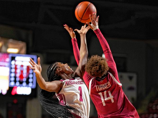 UMass’ Jermany Mapp (1), left, battles for a rebound with Harvard’s Harmoni Turner (14) during non-conference action at the Mullins Center in Amherst on Thursday night.