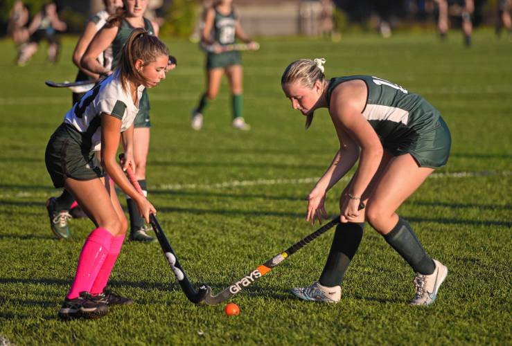 Greenfield’s Grace Laurie (23), left, battles for possession with Minnechaug’s McKenna Hale (10) during the Green Wave’s 2-1 Suburban League loss on Wednesday in Greenfield.