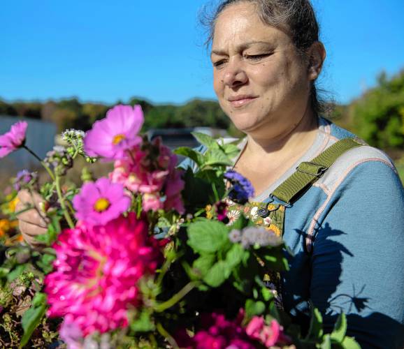 Suna Turgay, co-owner of Flowerwork Farm, makes bouquets after harvesting the flowers in fields in Florence on Oct. 13.