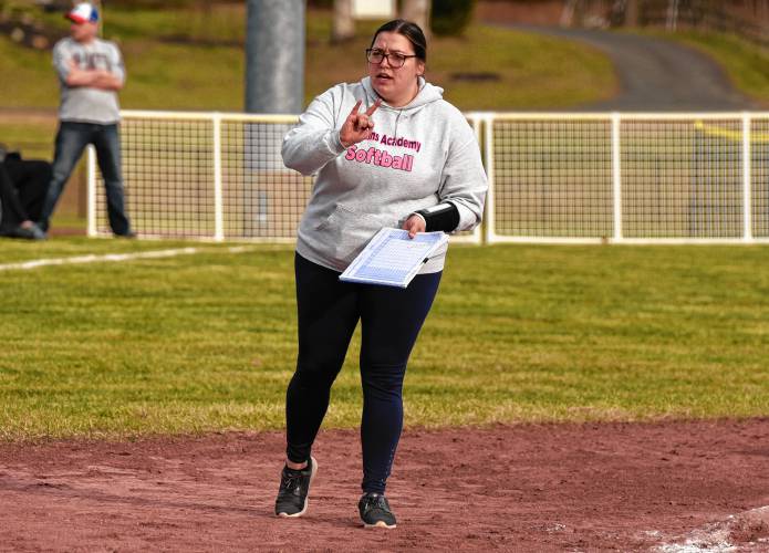 Hopkins Academy head coach Lindsey Lord gives a signal to one of her batters from the third base box against Turners Falls during the host Thunder’s season-opening victory on Monday at Gary  Mullins Field in Turners Falls.
